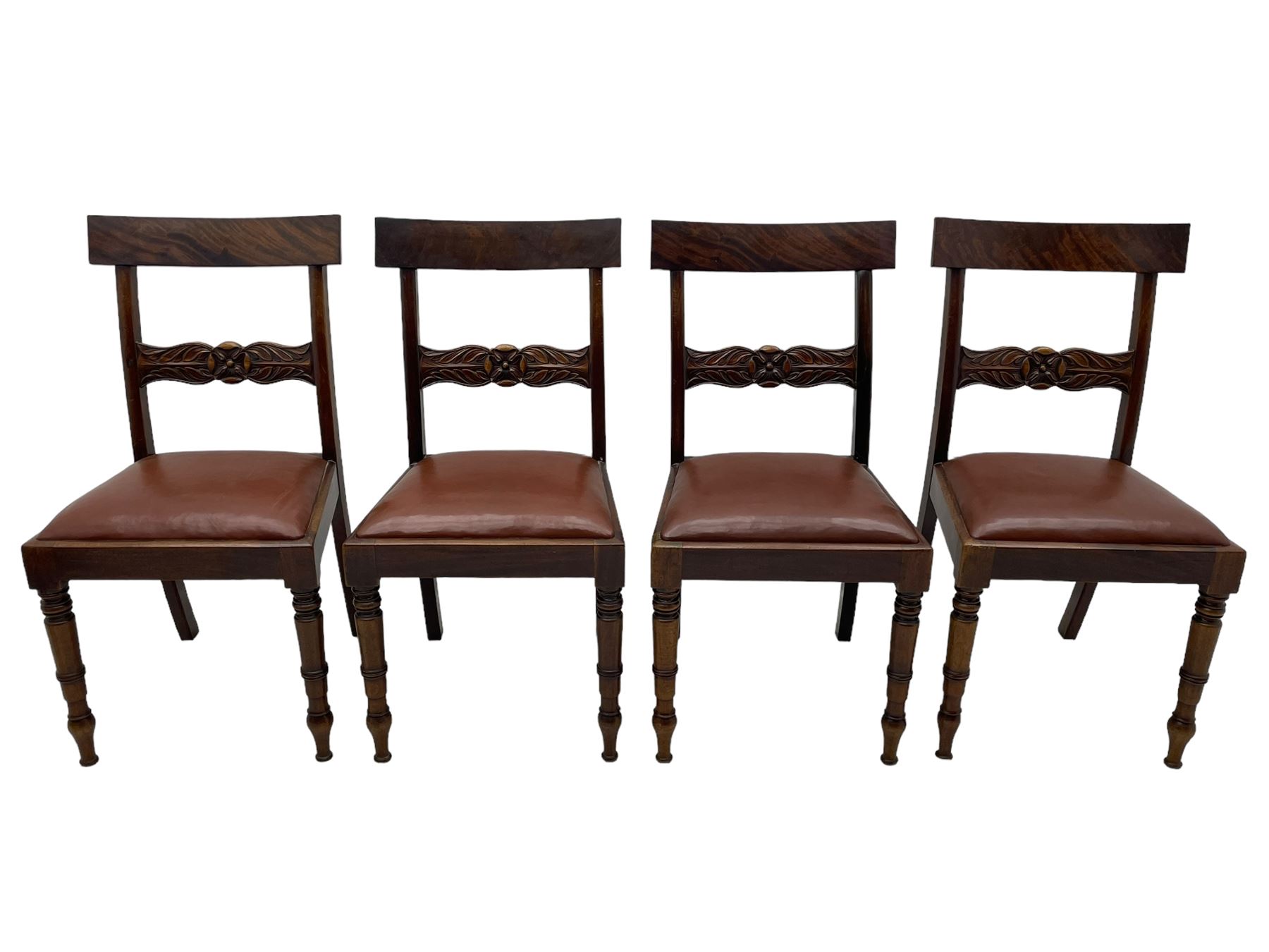 Set of six (4+2) early 19th century mahogany dining chairs, figured bar back over rose and curled leaf carved middle rail, drop-in seats upholstered in brown fabric, on turned front supports 