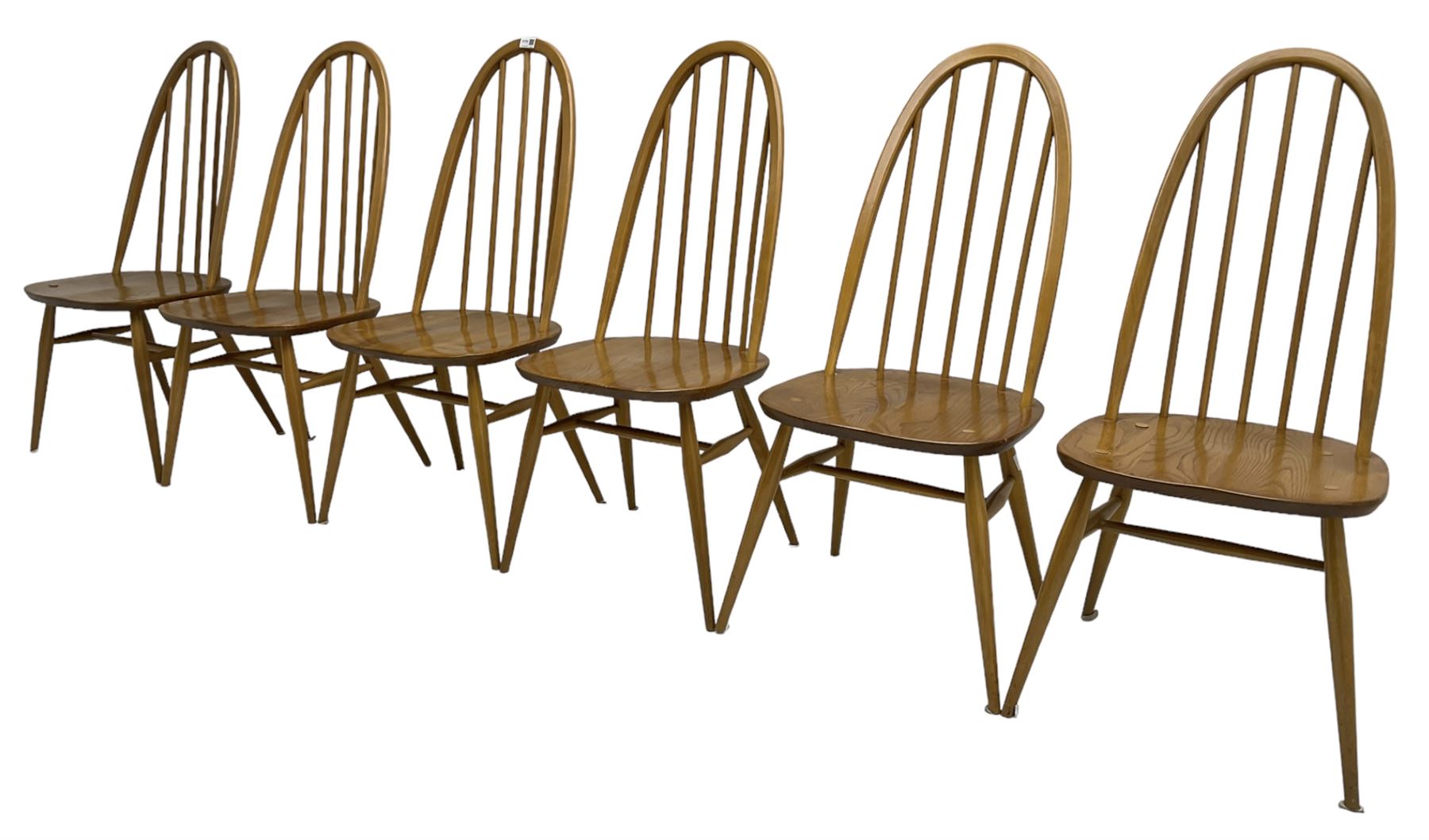 Ercol - light elm and beech set of ten (8+2) 'Quaker Windsor' dining chairs, high hoop and stick back over splayed supports united by H-stretcher, with foliate patterned crimson loose seat cushions